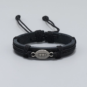 Detail of adjustable black woven leather bracelet with silver rugby metal charm feature