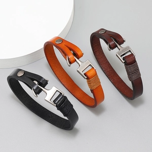 Set of three leather anchor bracelets in black, orange, and brown with metal hooks