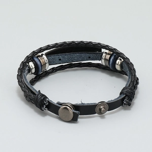 Detail of multi-layer black braided leather bracelet with metal rings and snap buttons