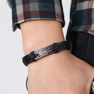 Hand-woven black leather bracelet for men featuring a silver metal rugby football charm