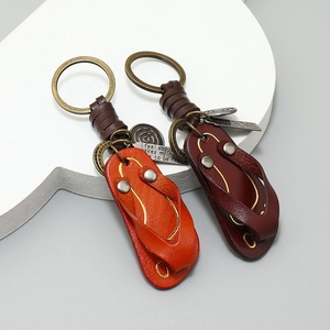 Vintage leather flip-flop keychains in orange and brown with retro bronze metal rings
