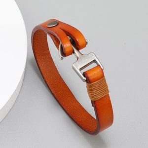 Detailed macro of brown leather bracelet with silver anchor hook and twine wrapping