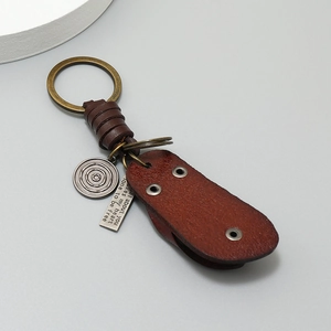 Retro brown leather keychain with vintage brass ring and engraved metal charms