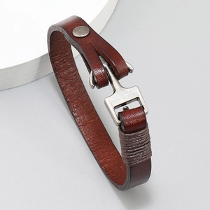 Detailed view of dark brown leather anchor bracelet with a silver matte metal hook clasp