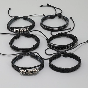 Detail of 6-piece men's punk bracelet set with leather weaving and silver skull charms