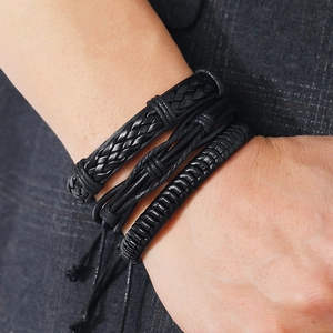 Nahaufnahme von drei schwarzen geflochtenen Lederarmbändern mit verschiedenen Webmustern