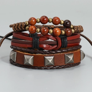 Macro detail of multi-layer brown leather bracelet with wooden beads and metal rivets