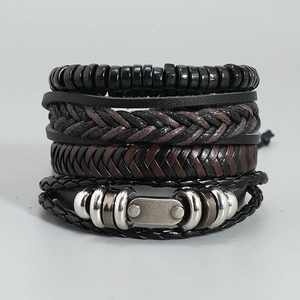 Detail view of a 4-piece set of men's woven leather bracelets with vintage metal charms