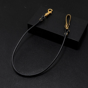 Detail of black leather trouser chain with vintage brass lobster clasp and hook