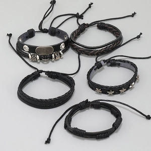 Detail of five-piece black woven leather bracelet set with retro silver charms and studs