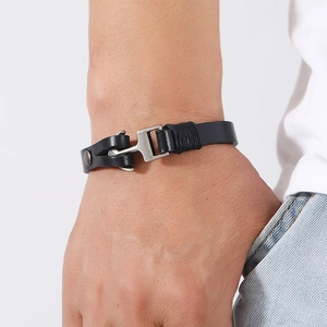 Detail of men's black leather anchor bracelet with vintage silver hook on wrist