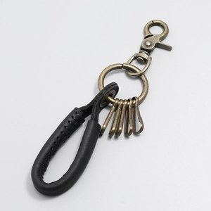 Detail view of vintage bronze swivel hook and 5 hooks on a black leather car keychain