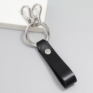Detail of black leather punk keychain with silver metal rings and lobster clasps