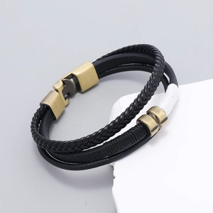 Detail of layered leather bracelet with bronze magnetic clasp and woven textures