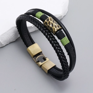 Multilayer black woven leather bracelet with bronze metal tube and green cotton thread wrap