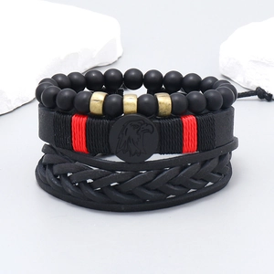 Set of three black leather bracelets with matte beads and eagle head detail on grey stones