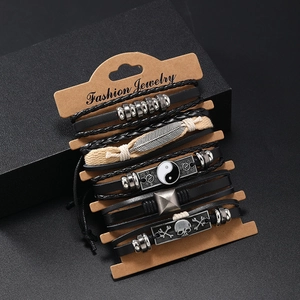 Multilayer leather bracelet set with feather and yin-yang charms on a display card