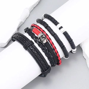 Bohemian 4-piece leather bracelet set with skull charm and beaded layers on white stand