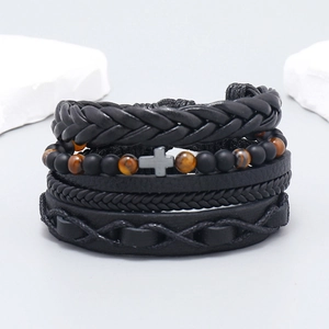 Detail of multi-layer woven leather bracelet set with cross charm and tiger eye beads