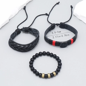 Detail of multi-layer leather bracelets with size guide and eagle charm detail