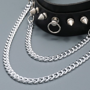 Detail view of black punk choker featuring metallic silver spikes and layered Cuban chains