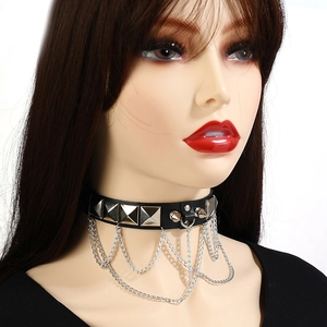 Detail of punk black leather choker with square silver studs and layered metal chains