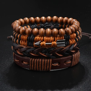 Detail of four-piece men's multilayer leather bracelets with wood beads and arrow charms
