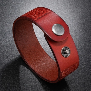 Close-up of red genuine leather bracelet featuring embossed Celtic knots and metal snaps