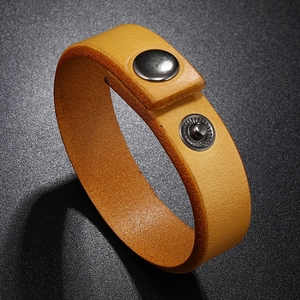 Detail view of ginger yellow leather bracelet with dark silver metal snap closure
