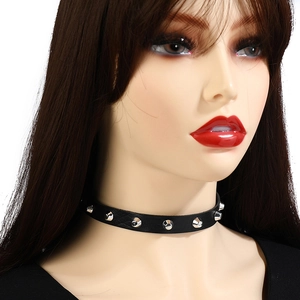 Close-up of black leather choker with silver metal cone studs in punk rock style