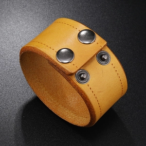 Macro detail of high-quality cowhide leather bracelet with stitching and metal snaps