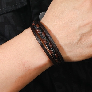 Classic multilayer braided leather bracelet for men in brown and black on a male wrist