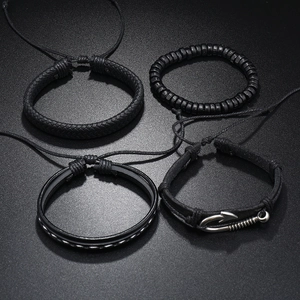 Detailed macro view of 4-piece multilayer black braided leather bracelets with silver accents
