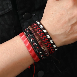Stack of four handmade bohemian leather bracelets for men featuring vibrant red and earth tones
