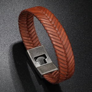 Close-up of brown braided leather bracelet with vintage magnetic industrial buckle