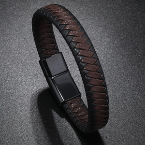 Detail of woven black and brown leather bracelet with sleek black magnetic metal clasp