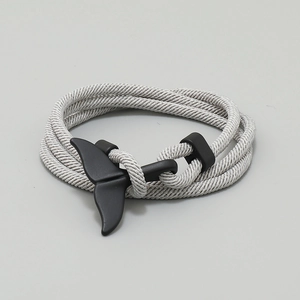 Close-up of minimalist woven Milanese rope bracelet with matte black whale tail clasp