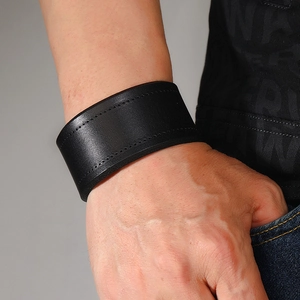 Detail of wide black leather cuff bracelet with premium double-row stitching detail