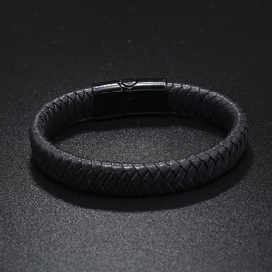Detail of multi-layer black braided leather bracelet featuring a sleek magnetic metal clasp