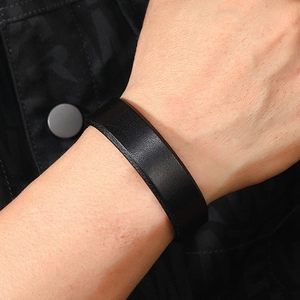 Close-up of black leather bracelet showing detailed texture and minimalist punk style