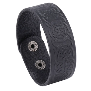 Vintage black leather bracelet featuring embossed Celtic knots and silver snap closures