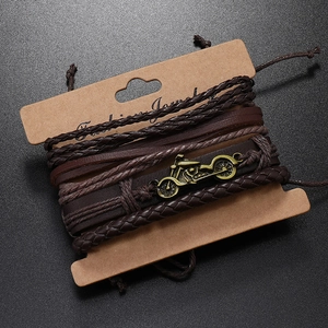 Detail view of multi-layer brown leather bracelet with vintage motorcycle metal charm