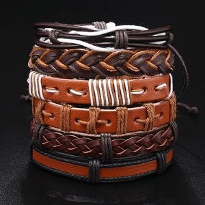 Close-up of handmade multilayer leather bracelets with braided rope and vintage details