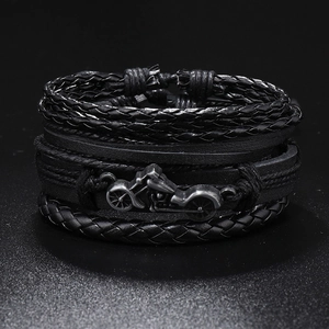 Detailed shot of multi-layer braided leather bracelet with vintage silver motorcycle pendant