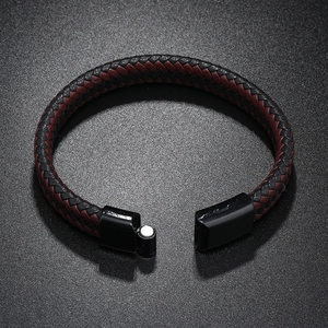 Detail of red and black braided leather bracelet with black magnetic metal clasp