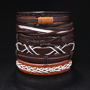 Macro view of multi-layer vintage leather bracelets featuring hand-woven textures and stitching
