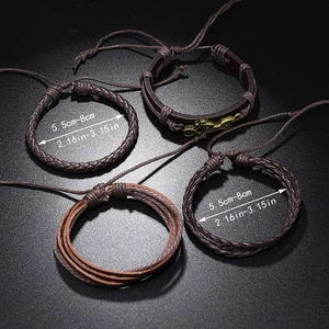 Close-up of four brown vintage leather bracelets with an adjustable diameter measurement guide
