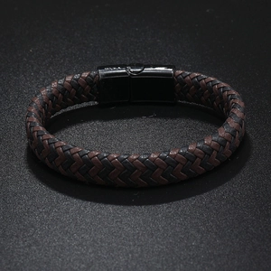 Close-up of woven black and brown leather bracelet with black magnetic metal clasp
