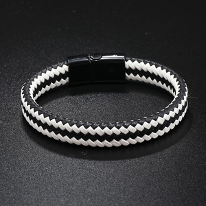 Close-up of black and white woven leather bracelet with polished magnetic buckle