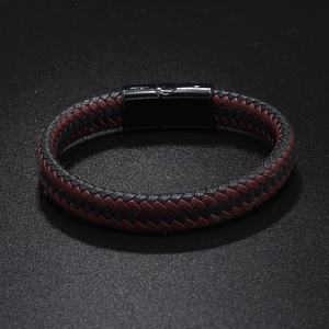 Detail of red and black braided leather bracelet with black magnetic metal clasp